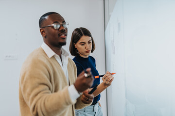Two colleagues engage in a dynamic brainstorming session, exchanging and discussing ideas on a...