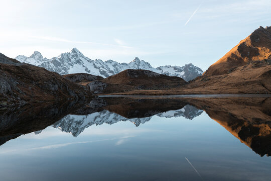 View of serene Lacs de Fenetre with majestic mountains and tranquil reflection, La Fouly, Switzerland.