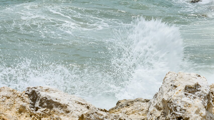 BALI, INDONESIA - JANUARY 22, 2018: Rocks and the Indian Ocean powerful crushing waves near Pandawa...