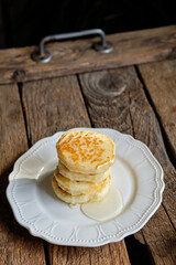 pancakes with honey. Wooden background, top view.
