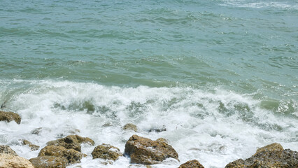 BALI, INDONESIA - JANUARY 22, 2018: Rocks and Indian Ocean relaxing waves near Pandawa Beach, Bali.