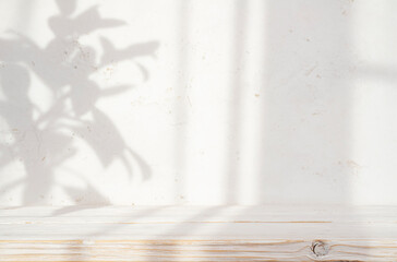 Blur cream white cement wall with soft beautiful dappled sunlight leaves shadows background for...