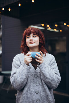 Cozy outdoor coffee break on a cool day with lights overhead