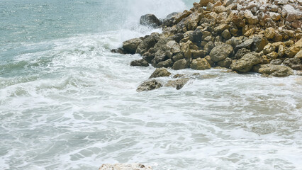 BALI, INDONESIA - JANUARY 22, 2018: Beautiful ocean waves hit rocks near Pandawa Beach, Bali.