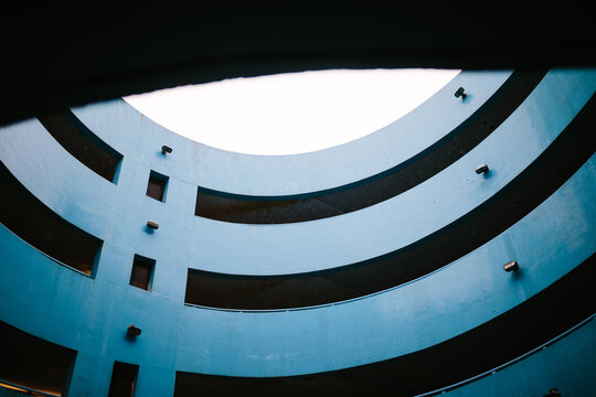 Blue parking lot structure with a modern curved design
