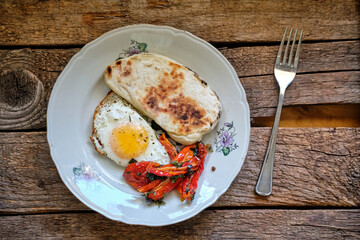 fried egg on a plate with pepper and bread.