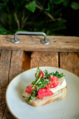 toast with arugula, tomatoes, cheese and sesame. homemade bread. Top view. Wooden background.