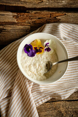 Rice pudding with milk decorated with edible flowers.