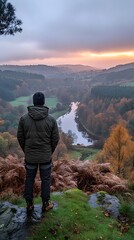 Obraz premium Mann blickt über eine herbstliche Flusslandschaft im Sonnenuntergang – Ruhe und Naturverbundenheit 