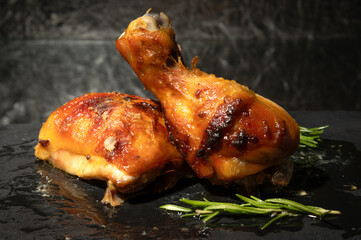Juicy roasted chicken drumsticks, perfect for food blogs, restaurant menus, or recipe promotions. Delicious and tempting dark background