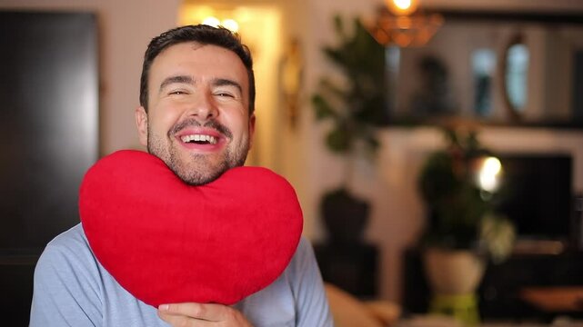 Handsome romantic man holding a heart 