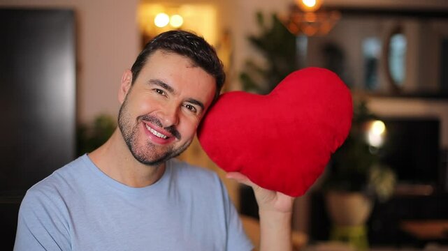 Handsome romantic man holding a heart 
