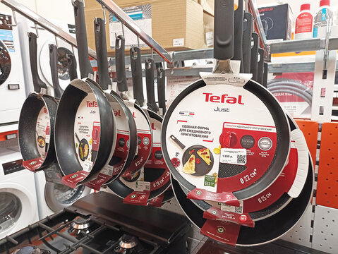 Collection of tefal frying pans on display in appliance store