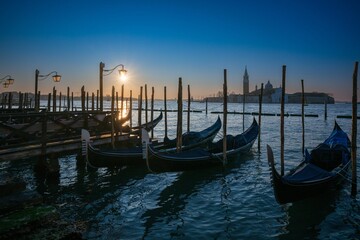 Venetian gondolas at sunset with San Giorgio Maggiore.