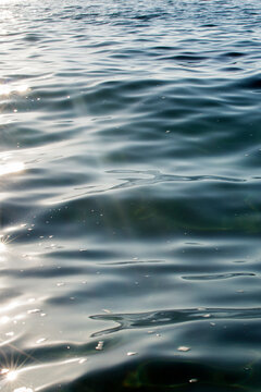 Calm ocean waves with sunlight reflections creating tranquility