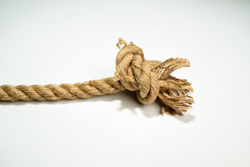 Closeup view of ropes string with a knot isolated over a white background