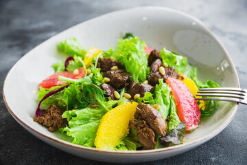 Tasty salad with meat, citrus and leaves, healthy diet food