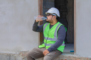 Asian engineering contractor working wearing safety vest and helmet inspect construction site takes...