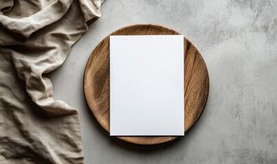 White blank menu on a wooden plate, top view mockup with a brown napkin on a gray background, flat lay