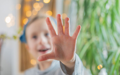 Close-up child's hand, Young child, girl laughing happily, extending hand, capturing moment...