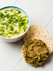 Healthy food, liver pate with butter and green onions in a bowl and beef liver pate on rice bread...