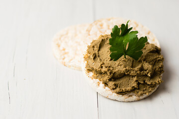 Healthy food, crispy rice cakes and liver pate on light table