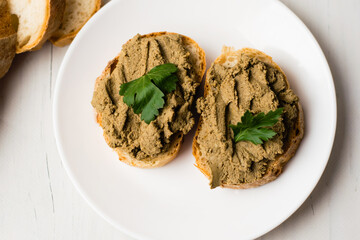 Healthy food, sandwiches with liver pate and a baguette with a crispy crust on a light background