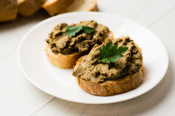 Healthy food, sandwiches with liver pate and a baguette with a crispy crust on a light background