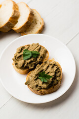 Healthy food, sandwiches with liver pate and a baguette with a crispy crust on a light background