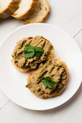 Healthy food, sandwiches with liver pate and a baguette with a crispy crust on a light background