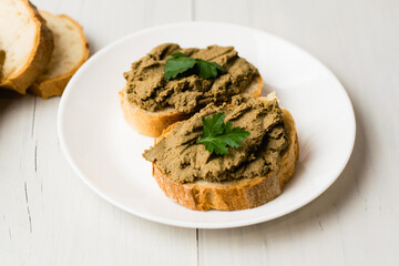 Healthy food, sandwiches with liver pate and a baguette with a crispy crust on a light background