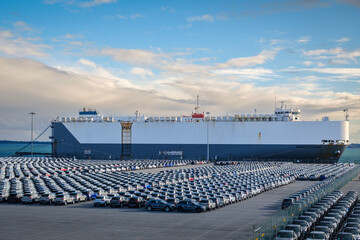 Vehicle carrier or RO-RO ship at port with rows of cars lined up