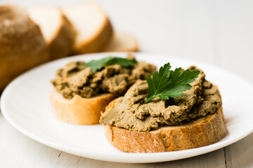 Healthy food, sandwiches with liver pate and a baguette with a crispy crust on a light background