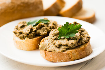 Healthy food, sandwiches with liver pate and a baguette with a crispy crust on a light background