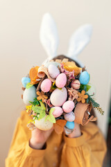 Easter themed bouquet held by caucasian young female with bunny ears