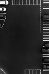 Obraz premium Overhead view of a mostly empty parking lot with several cars parked.