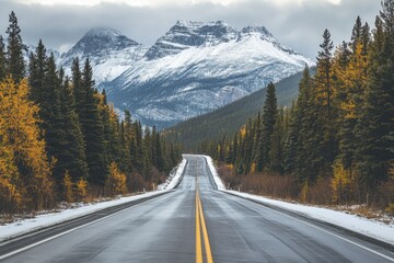 Fototapeta premium Wet asphalt road leading to snowy mountain peaks through autumn forest