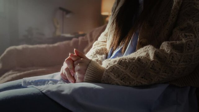 Nervous woman fidgets with fingers in psychotherapy office