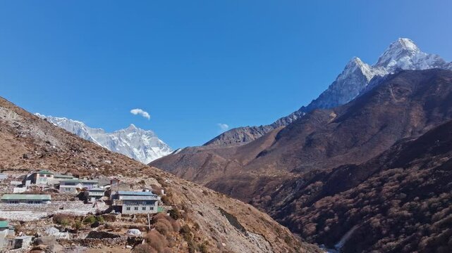Aerial view capturing Mount Everest, Ama Dablam and Himalayan landscape, revealing remote village of Shomare nestled in rocky terrain