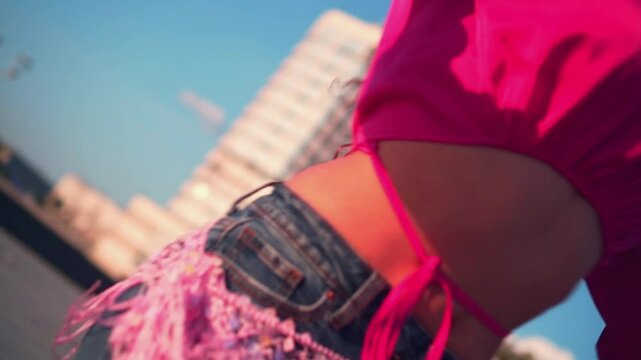 Close-up of a woman's belly with jewelry. Sexy woman dancing belly dance in jeans.