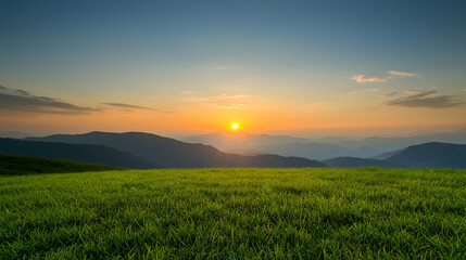 Obraz premium Sunset over mountain range, grassy field foreground, peaceful landscape, nature background, ideal for travel brochures