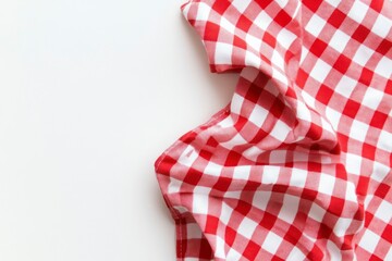 Fototapeta premium Red and white checkered tablecloth, white background, flat lay. A red gingham-patterned cloth folded neatly on top of the solid-color surface. Image isolated on a transparent background.