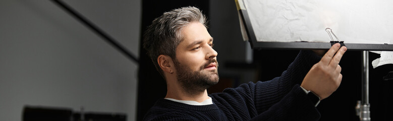 Fototapeta premium Creative professional adjusting lighting setup for a striking visual composition