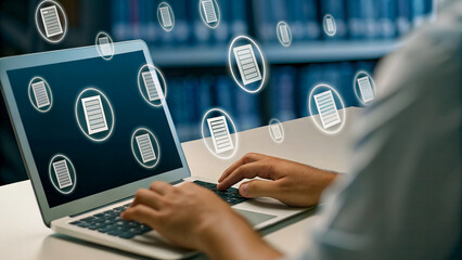 Person working on laptop with document icons overlay, library setting