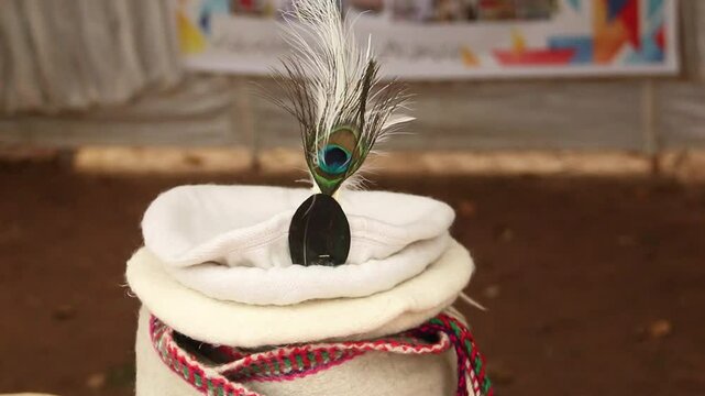 Traditional Pakol with Peacock Feather, traditional cap, pakol hat, traditional pakol hat on display in lok virsa mela, islamabad 
