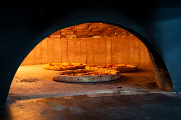 pizza oven in italy with pizza being cooked