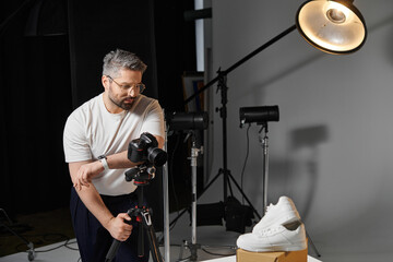 Creative process of a skilled photographer capturing products in a studio setting