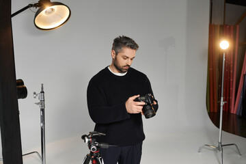 Creative man preparing equipment for a studio shoot in an artistic environment