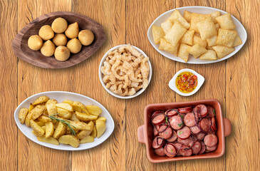 Assorted bar and pub food over wooden background
