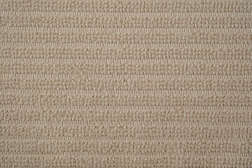 Textile close up of a beige fabric, fabric texture as a background.